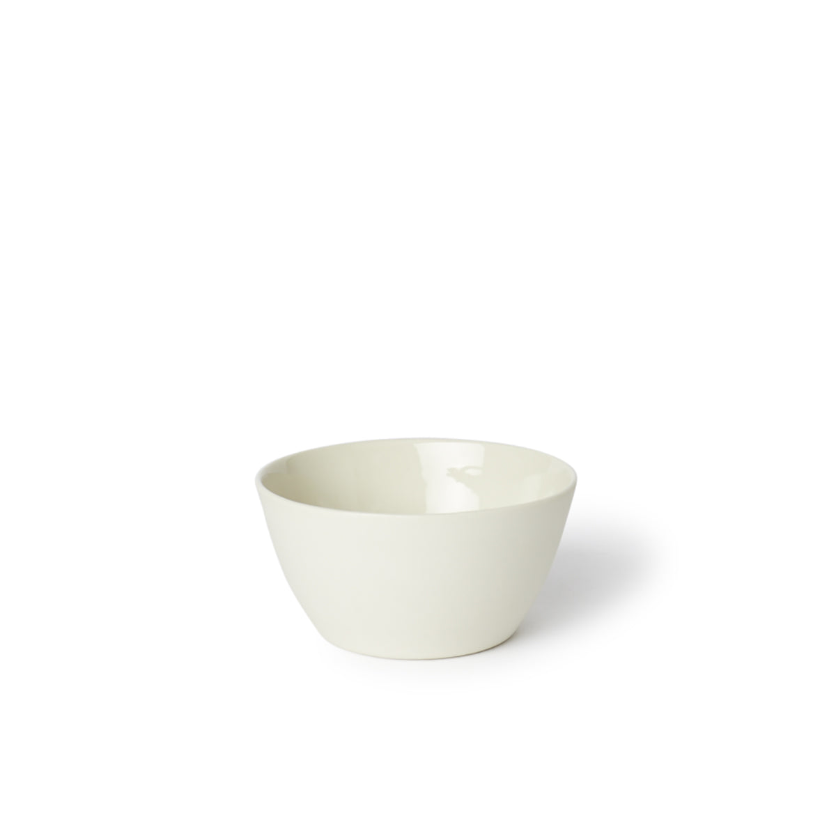 A beige, flat-bottomed porcelain rice bowl with a clear glaze interior.